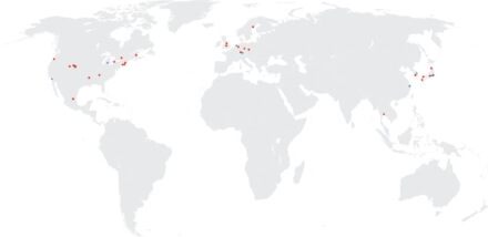 An illustrative world map with multi-colored pins showing CoorsTek Headquarters, manufacturing facilities, and sales offices.